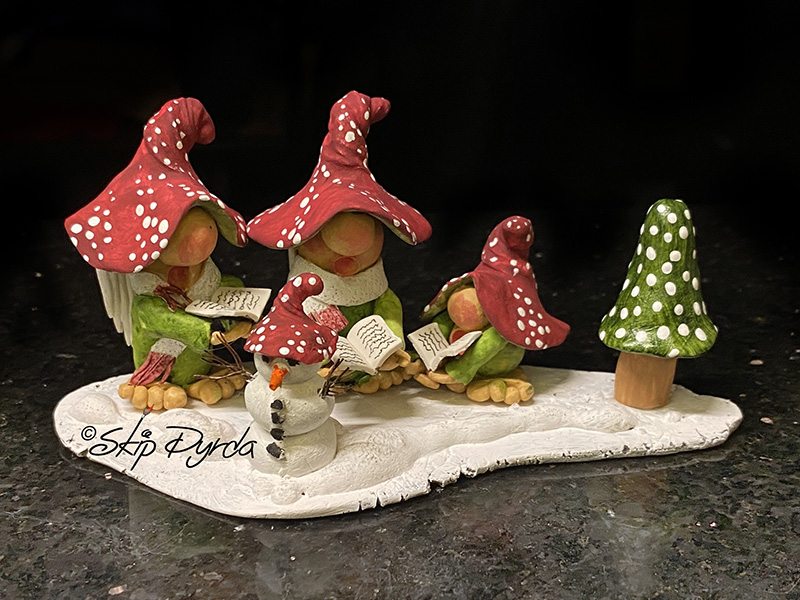 Painted clay gnome figurines that look like carolers