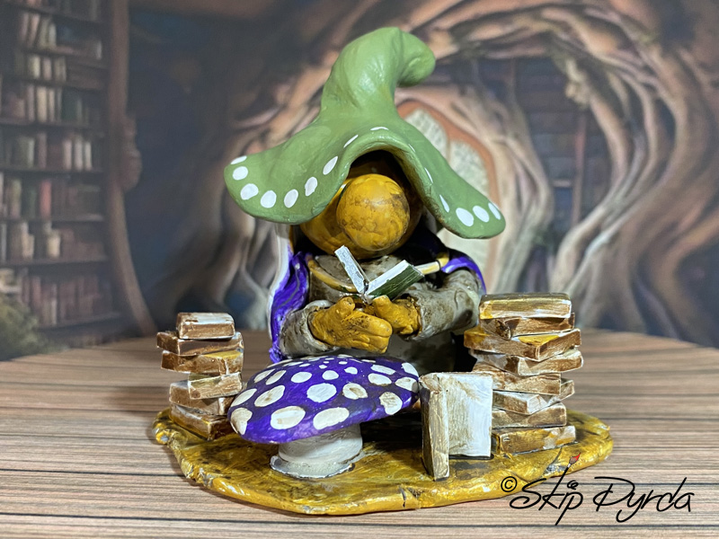 Painted clay gnome figurine as a librarian
