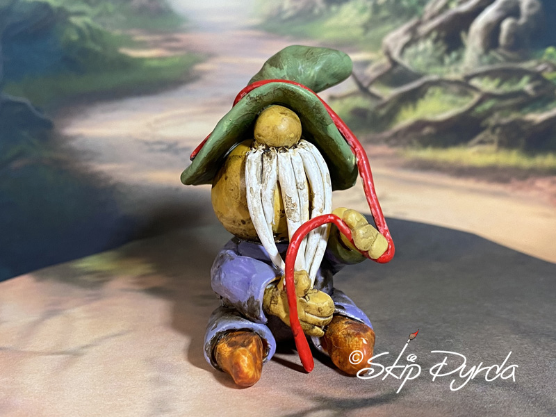 Painted clay gnome figurine with his red string