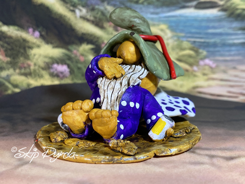Painted clay gnome figurine sleeping