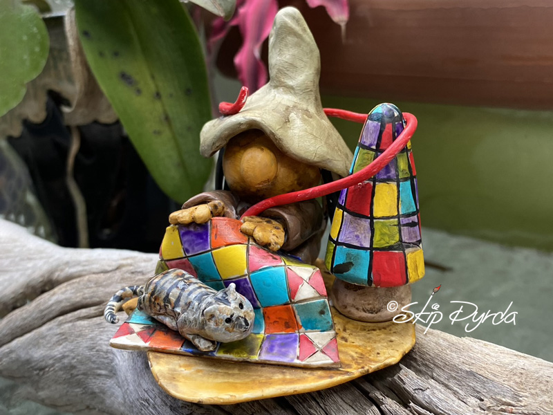 Painted clay gnome figurine as a quilt maker